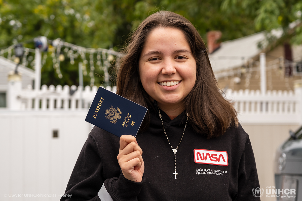 laura holds up her passport