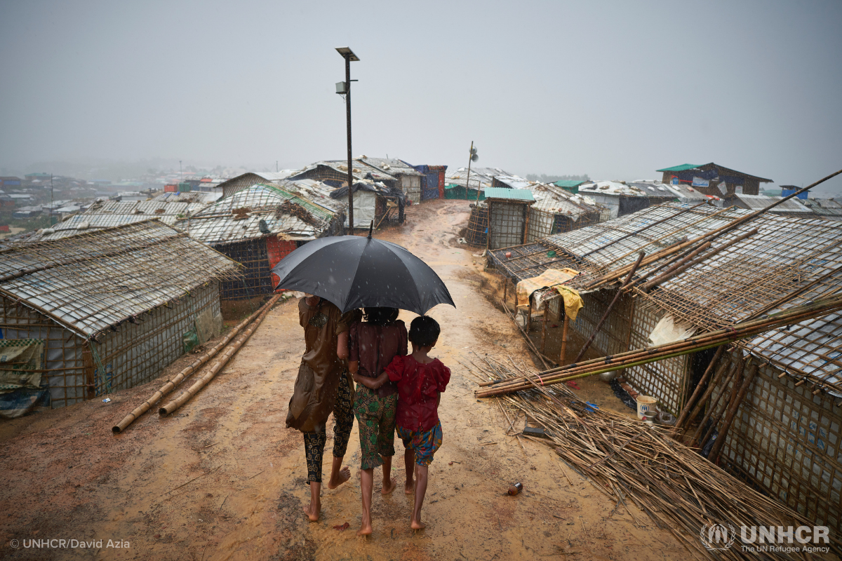 Rohingya children under umbrella during monsoon in Bangladesh